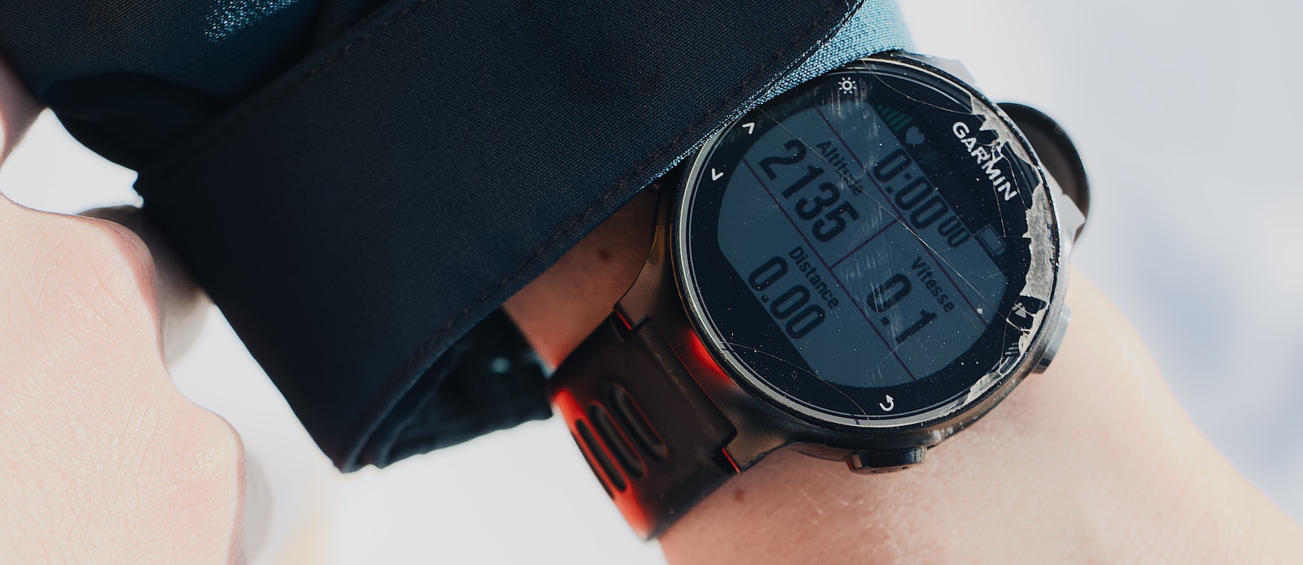 Garmin watch on a sailor's wrist showing GPS speed and distance